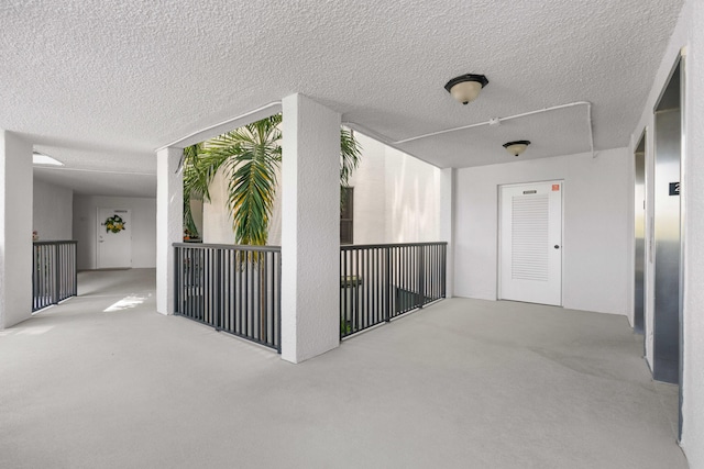 corridor featuring elevator and carpet