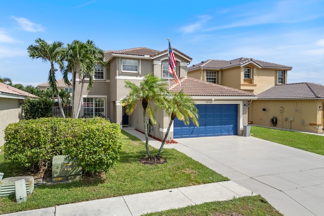 mediterranean / spanish house featuring a front yard and a garage