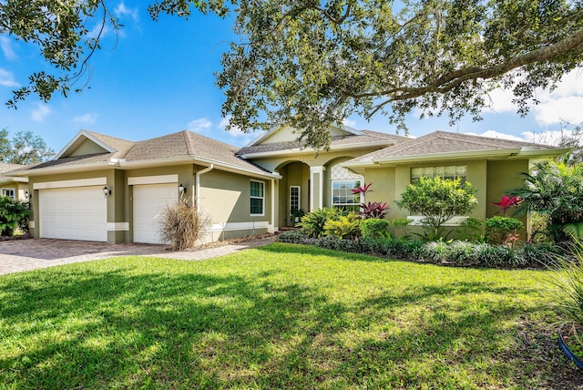 single story home with a front yard and a garage