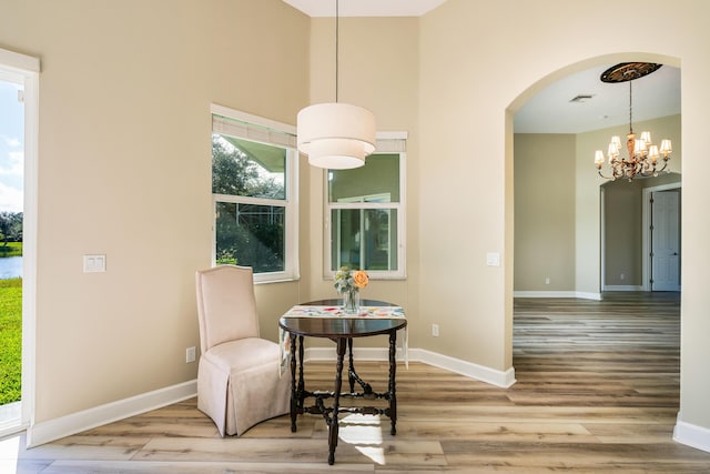 sitting room with a chandelier and wood-type flooring