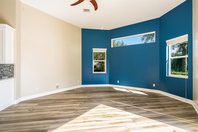 spare room featuring ceiling fan and light hardwood / wood-style floors