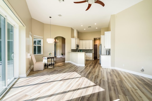 kitchen featuring appliances with stainless steel finishes, tasteful backsplash, ceiling fan, decorative light fixtures, and white cabinetry