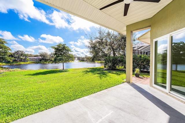 view of patio featuring a water view and ceiling fan