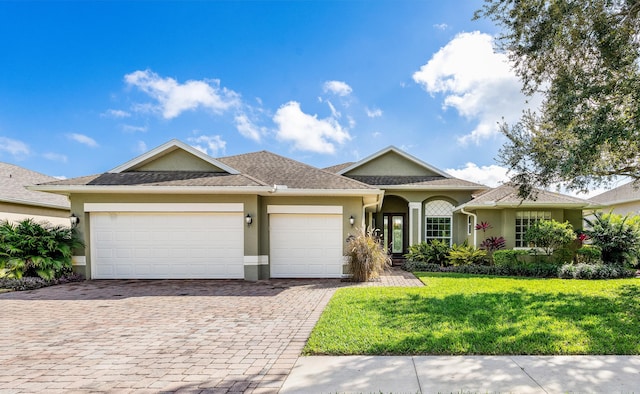 view of front of home featuring a garage and a front lawn