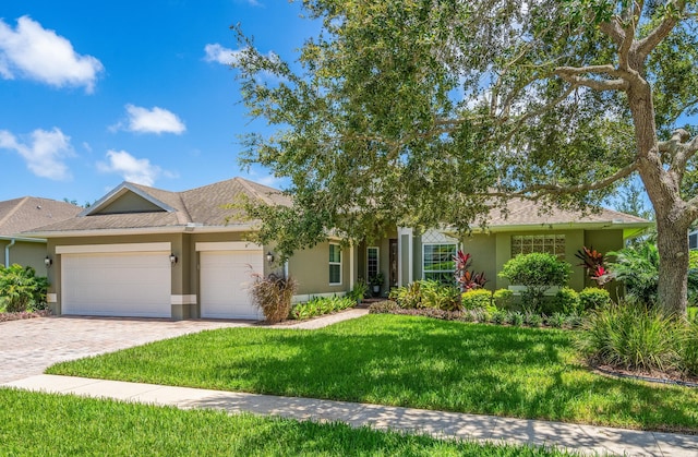 view of front of property with a front lawn and a garage