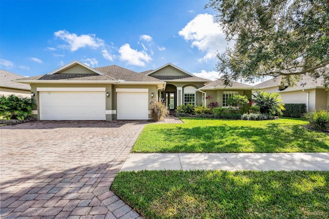 single story home featuring a front lawn and a garage