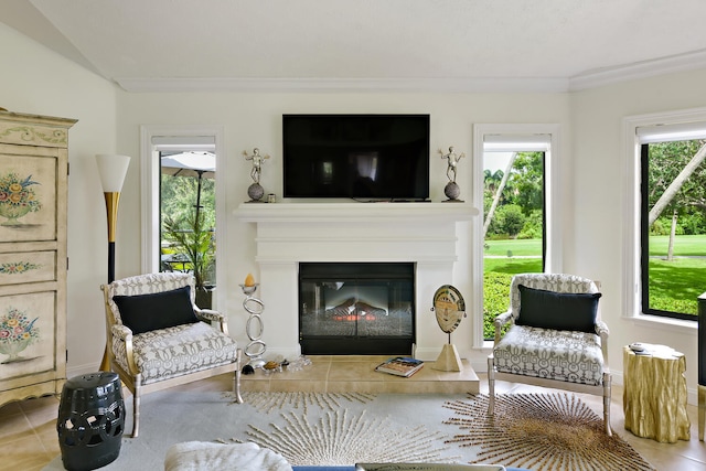 sitting room with ornamental molding and tile patterned flooring