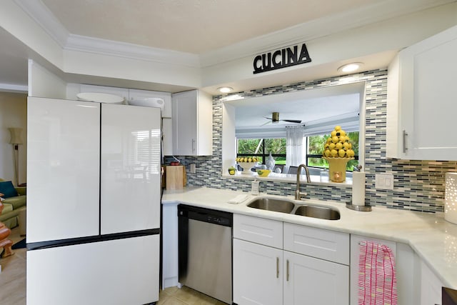 kitchen featuring white fridge, white cabinetry, sink, and dishwasher