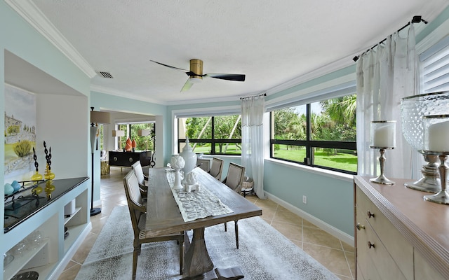 interior space with a textured ceiling, ornamental molding, a wealth of natural light, and ceiling fan