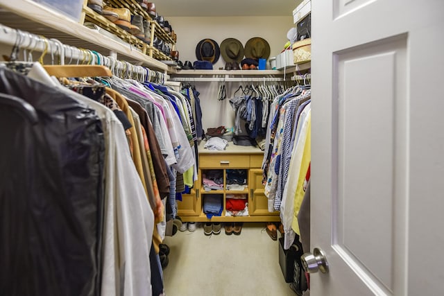 walk in closet with carpet floors