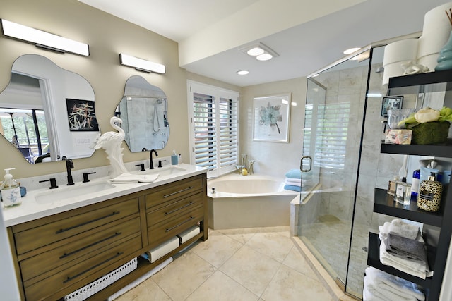 bathroom featuring tile patterned floors, vanity, and shower with separate bathtub