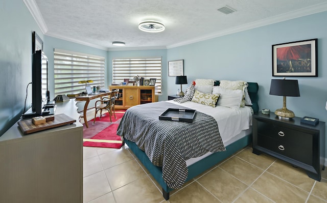 bedroom with light tile patterned flooring, crown molding, and a textured ceiling