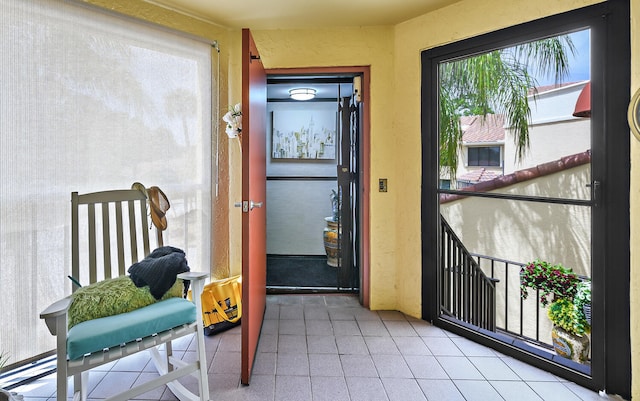 doorway featuring plenty of natural light and tile patterned floors