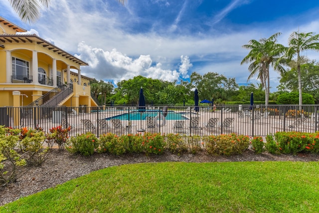 view of pool with a yard