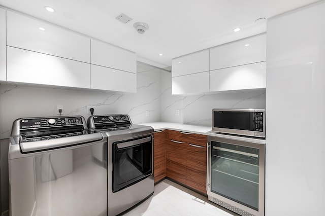 laundry area featuring washer and clothes dryer and wine cooler