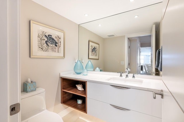 bathroom featuring vanity and toilet