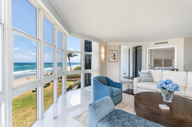 living room featuring a view of the beach and a water view