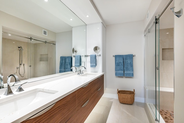 bathroom with tile patterned floors, walk in shower, and vanity