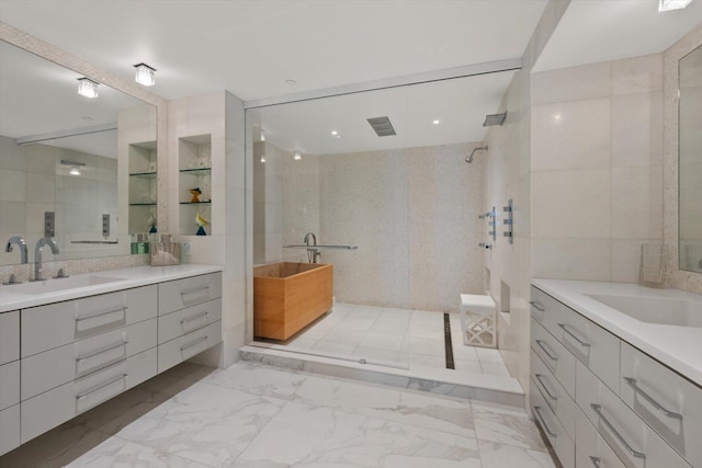 bathroom with tile walls, independent shower and bath, and vanity