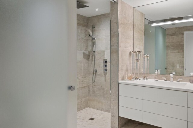 bathroom with walk in shower and vanity