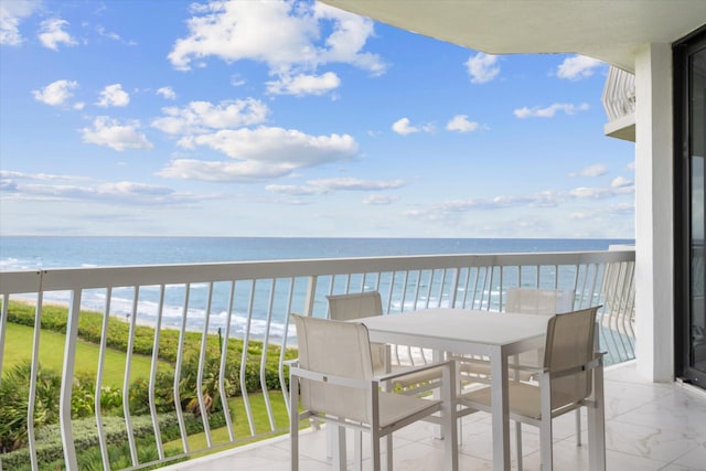 balcony featuring a water view and a beach view