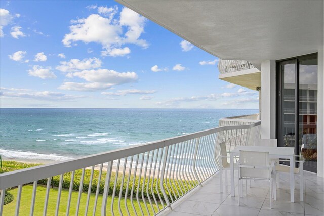 balcony with a view of the beach and a water view