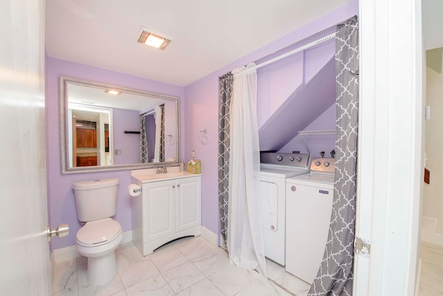 bathroom with vanity, toilet, and washing machine and dryer