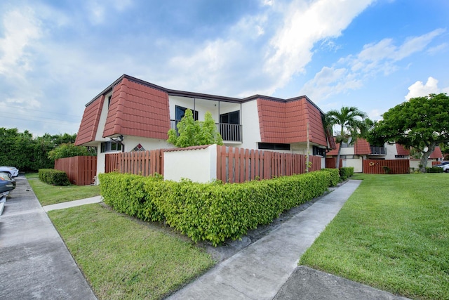 view of side of home featuring a lawn