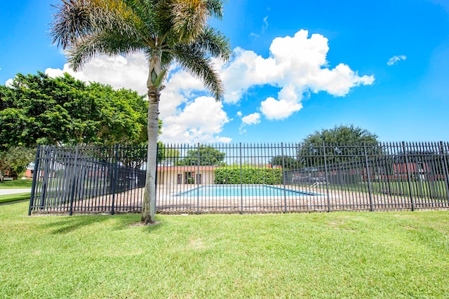 view of pool featuring a yard