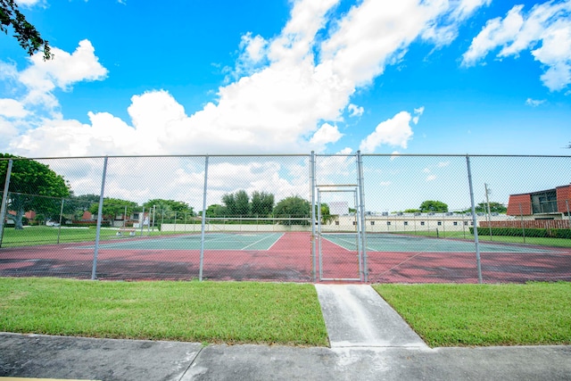 view of sport court with a yard