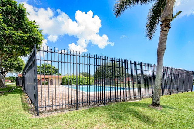 view of swimming pool with a patio area and a yard