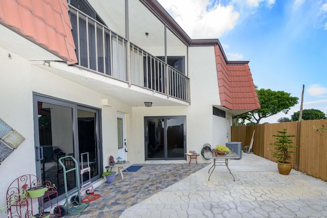 back of house featuring a patio, a balcony, and central AC