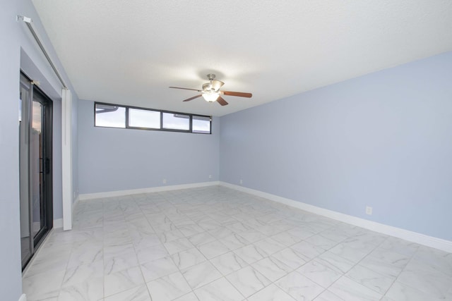 spare room with ceiling fan and a textured ceiling