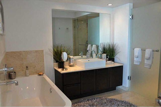 bathroom featuring vanity and shower with separate bathtub