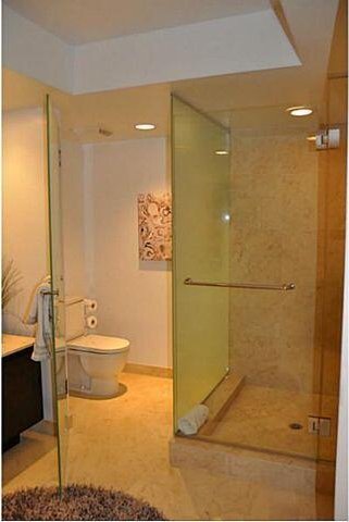 bathroom with vanity, toilet, and an enclosed shower