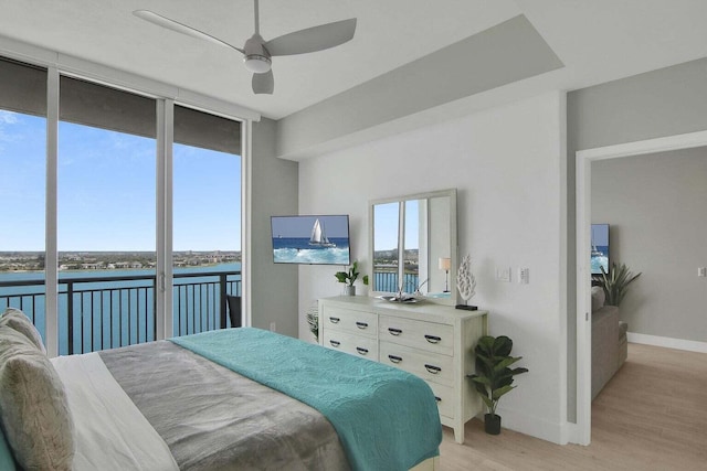 bedroom featuring light hardwood / wood-style floors, access to outside, and ceiling fan