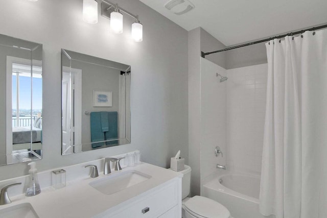 full bathroom with vanity, shower / tub combo, and toilet