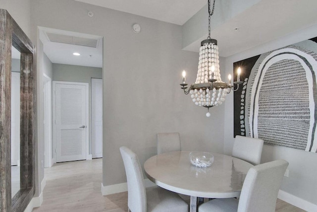 dining room featuring light hardwood / wood-style flooring and an inviting chandelier