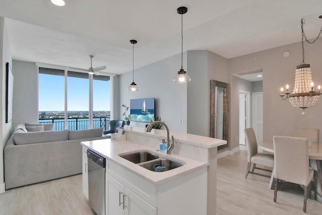 kitchen with a center island with sink, white cabinetry, dishwasher, and light hardwood / wood-style flooring