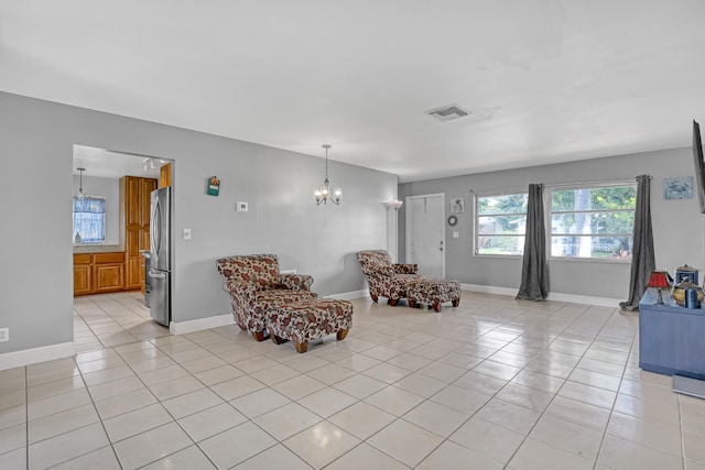 sitting room featuring light tile patterned floors and a chandelier