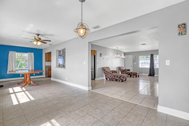 unfurnished room featuring ceiling fan and light tile patterned floors