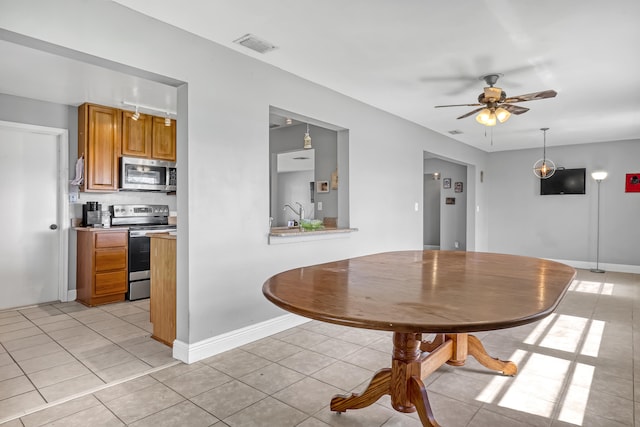 dining room featuring ceiling fan and light tile patterned floors