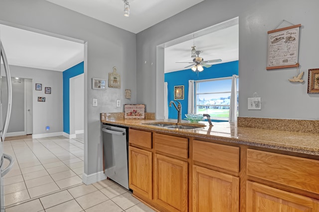 kitchen with ceiling fan, light tile patterned floors, sink, and stainless steel dishwasher