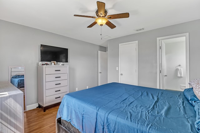 bedroom featuring light wood-type flooring, connected bathroom, and ceiling fan