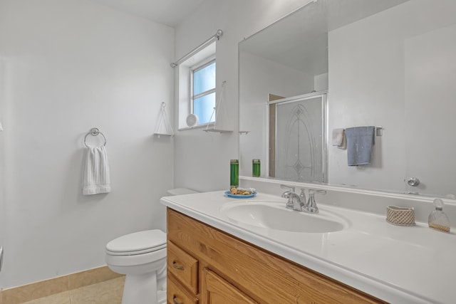 bathroom featuring vanity, tile patterned flooring, toilet, and an enclosed shower