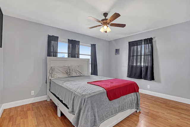 bedroom with ceiling fan and hardwood / wood-style floors