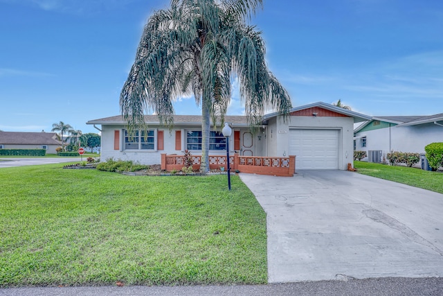 ranch-style house featuring a garage, central air condition unit, and a front yard