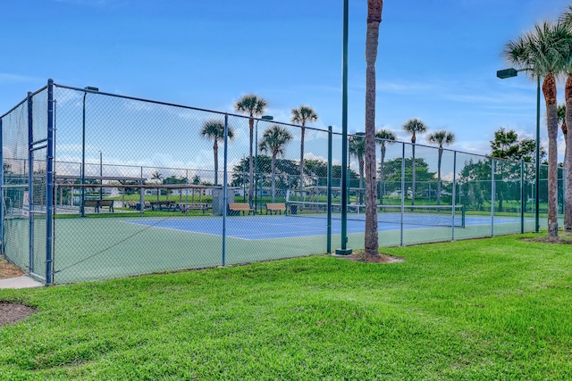 view of tennis court with a lawn