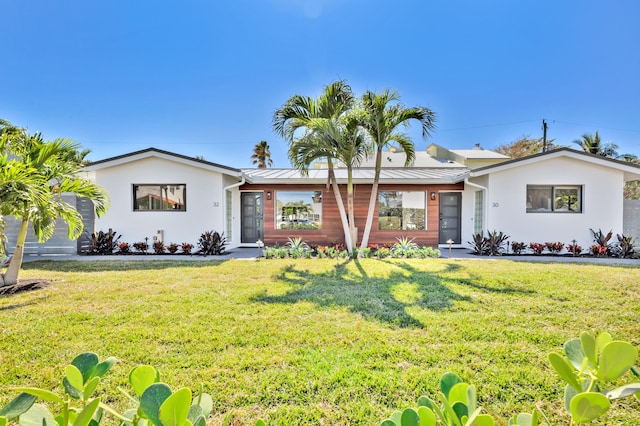 single story home featuring a front lawn