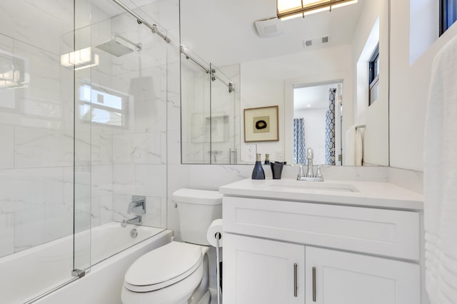 full bathroom with shower / bath combination with glass door, vanity, and toilet